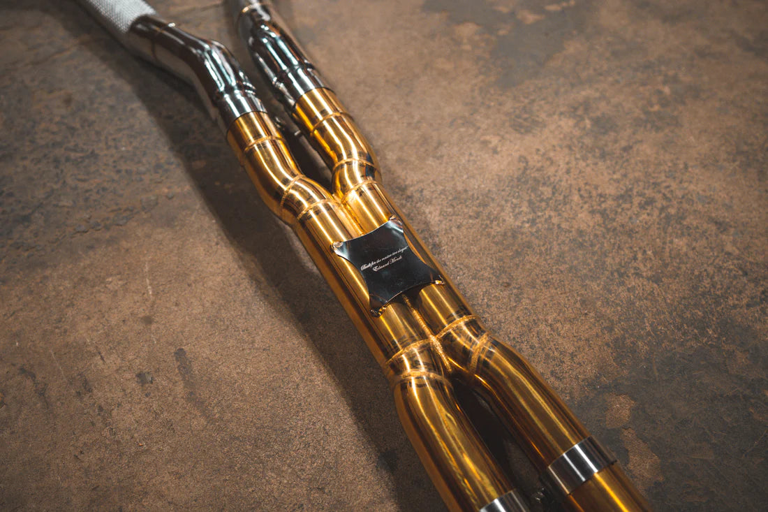 A close up view of Valvetronic Designs Ferrari Valved Exhaust system's pipes on the ground (for GTC4 Lusso).