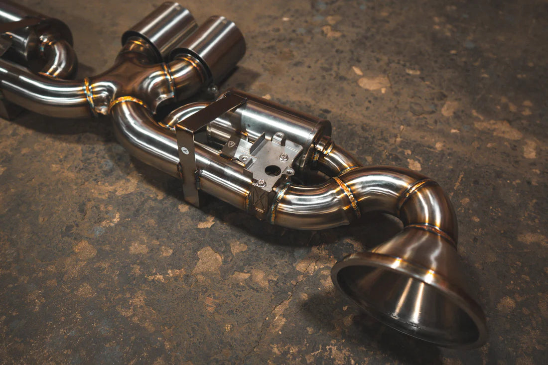 A side overview of Valvetronic Designs Valved Sport Exhaust System on the ground (for Porsche 992 GT3/ RS).