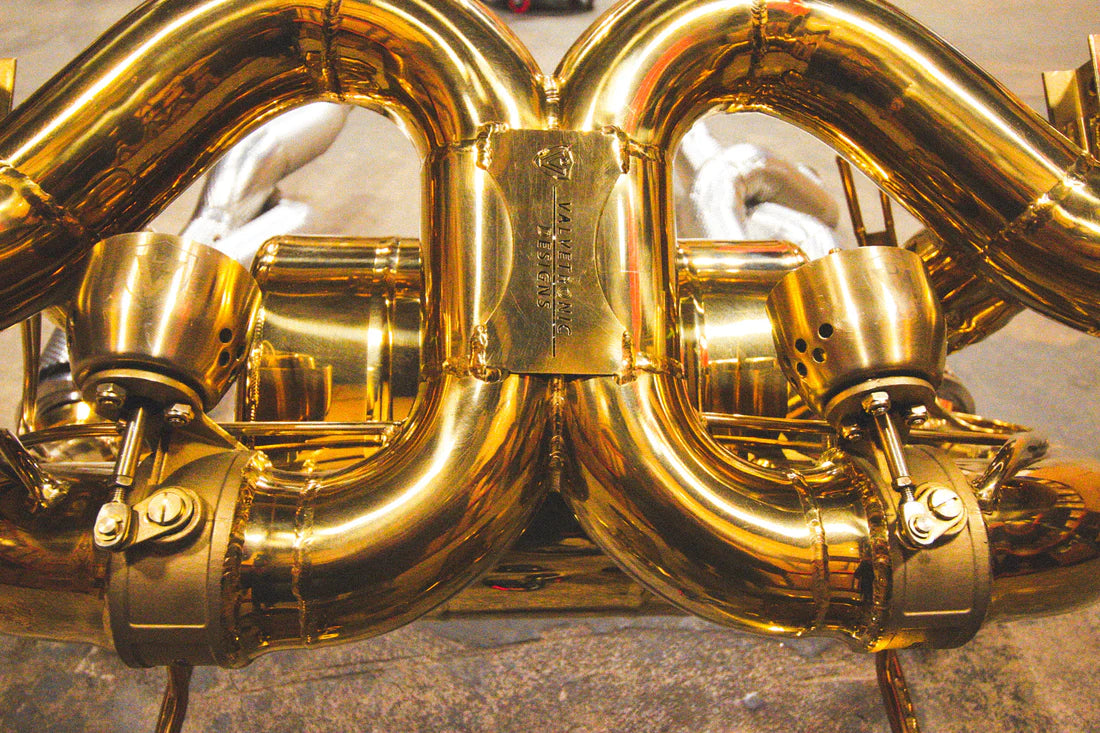 A close up view of Valvetronic Designs Valved Sport Exhaust System on the ground (for Lamborghini Aventador SVJ/Ultimae).