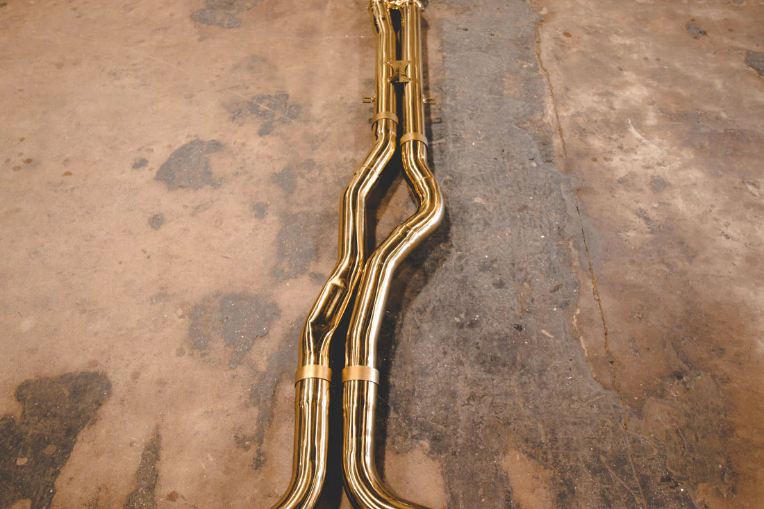 A top overview of Valvetronic Designs Stainless Steel Valved Sport Exhaust System's pipes on the ground (for Mercedes W205 C63 / C63s).