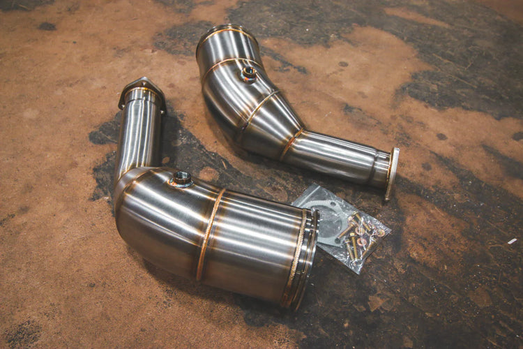 A top view of Valvetronic Designs Free Flow Race Front Pipes (for Audi RS6 / RS7 C8) on the ground.