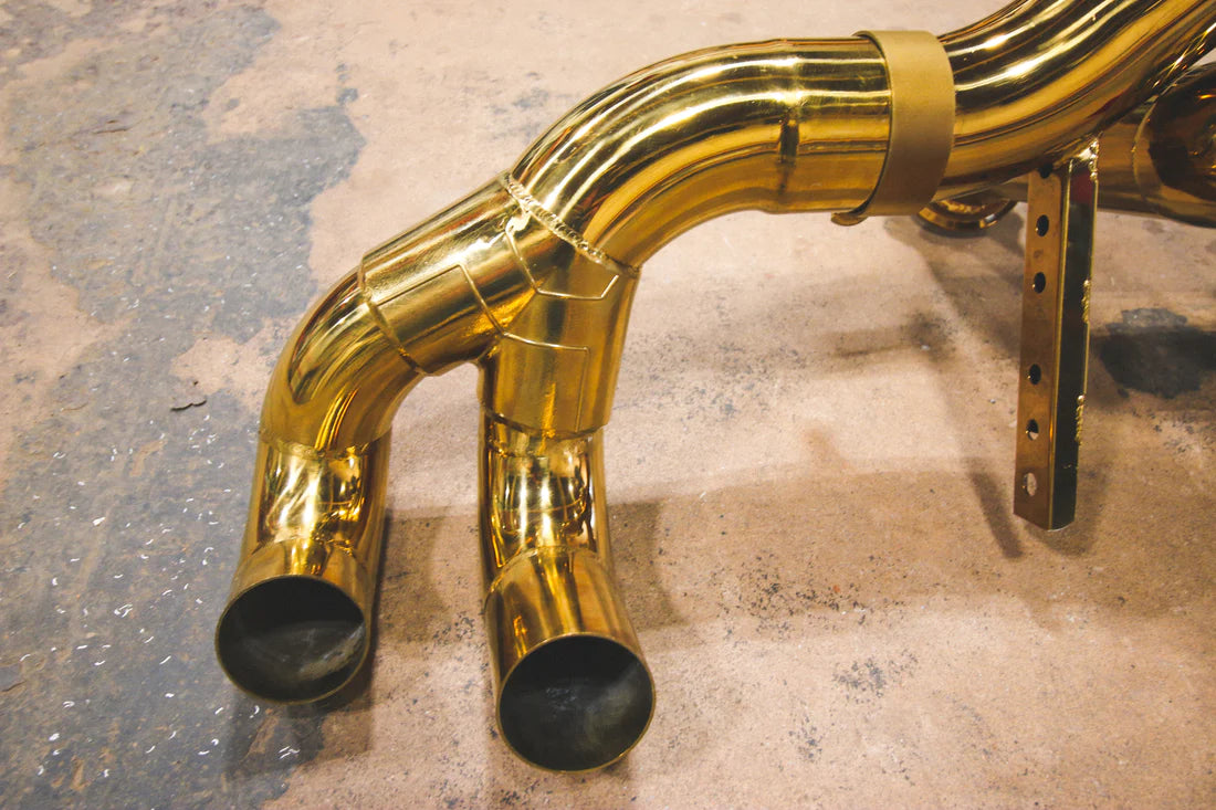 A close up view of Valvetronic Designs Valved Sport Exhaust System's pipes on the ground (for Lamborghini Huracan).