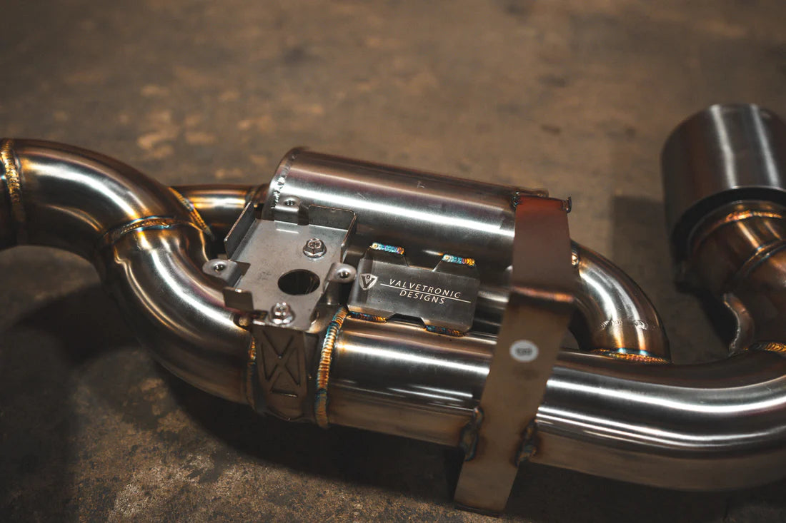 A close overview of Valvetronic Designs Valved Sport Exhaust System on the ground (for Porsche 992 GT3/ RS).