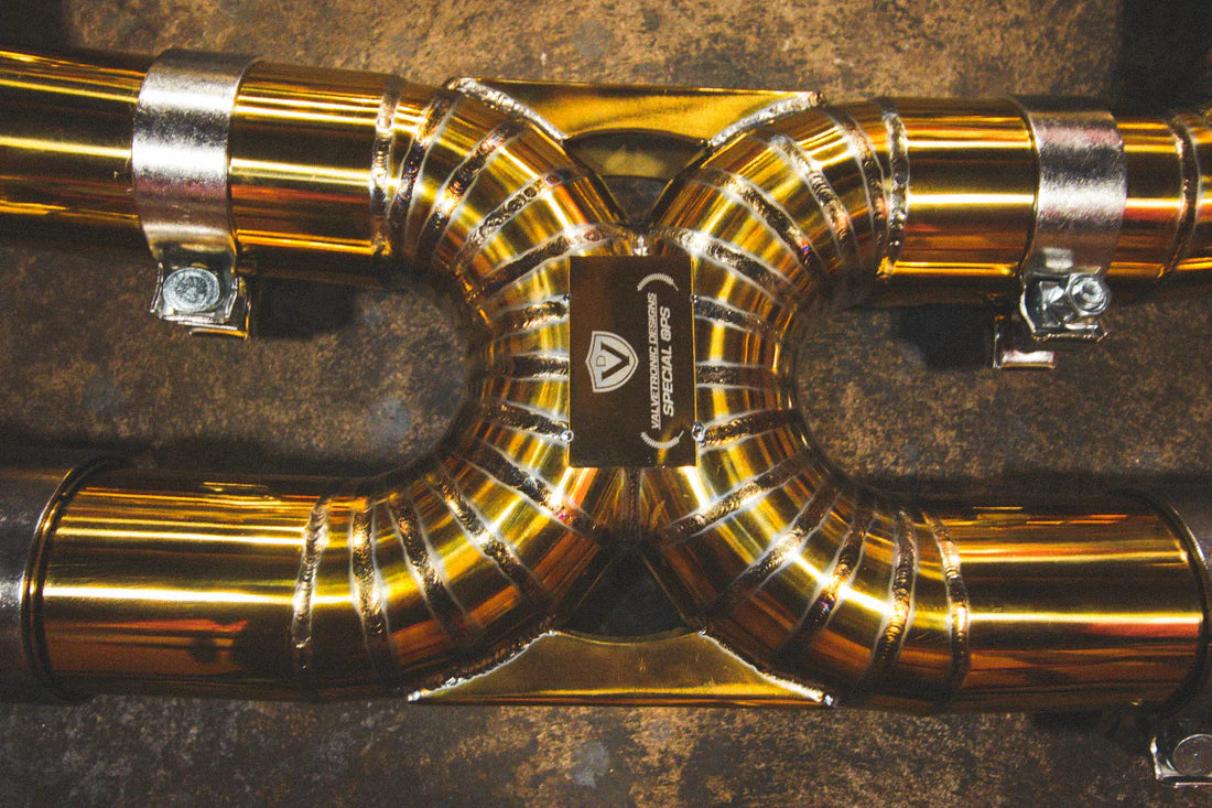 A close up view of Valvetronic Designs Valved Sport Exhaust System's pipes on the ground (for Chevrolet Corvette C8).