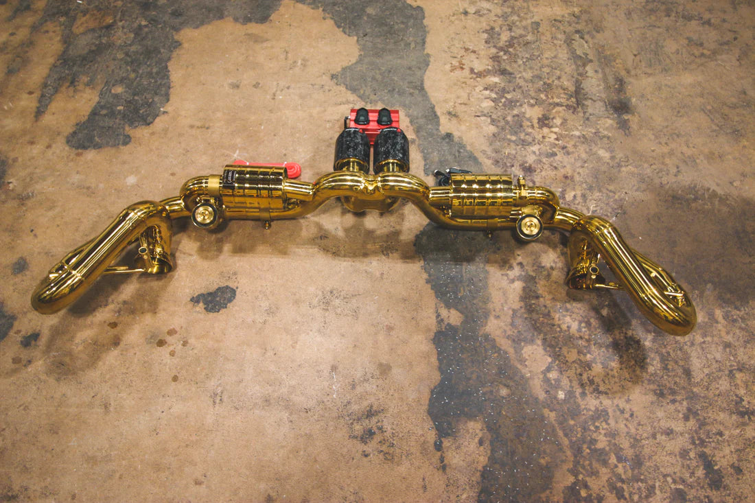 A top overview of Valvetronic Designs Valved Sport Exhaust System with valve controllers on the ground (for Porsche 991 GT3 / RS).