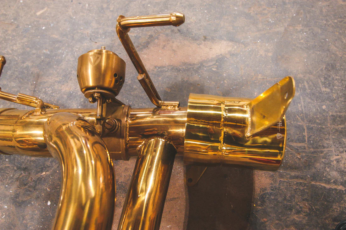 A close up view of a part of Valvetronic Designs Valved Sport Exhaust System on the ground (for Ferrari 488 GTB and Pista).