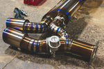 A side overview of Valvetronic Designs Valved Race Exhaust System's exhaust tips on the ground (for Porsche 991 Turbo / Turbo S).