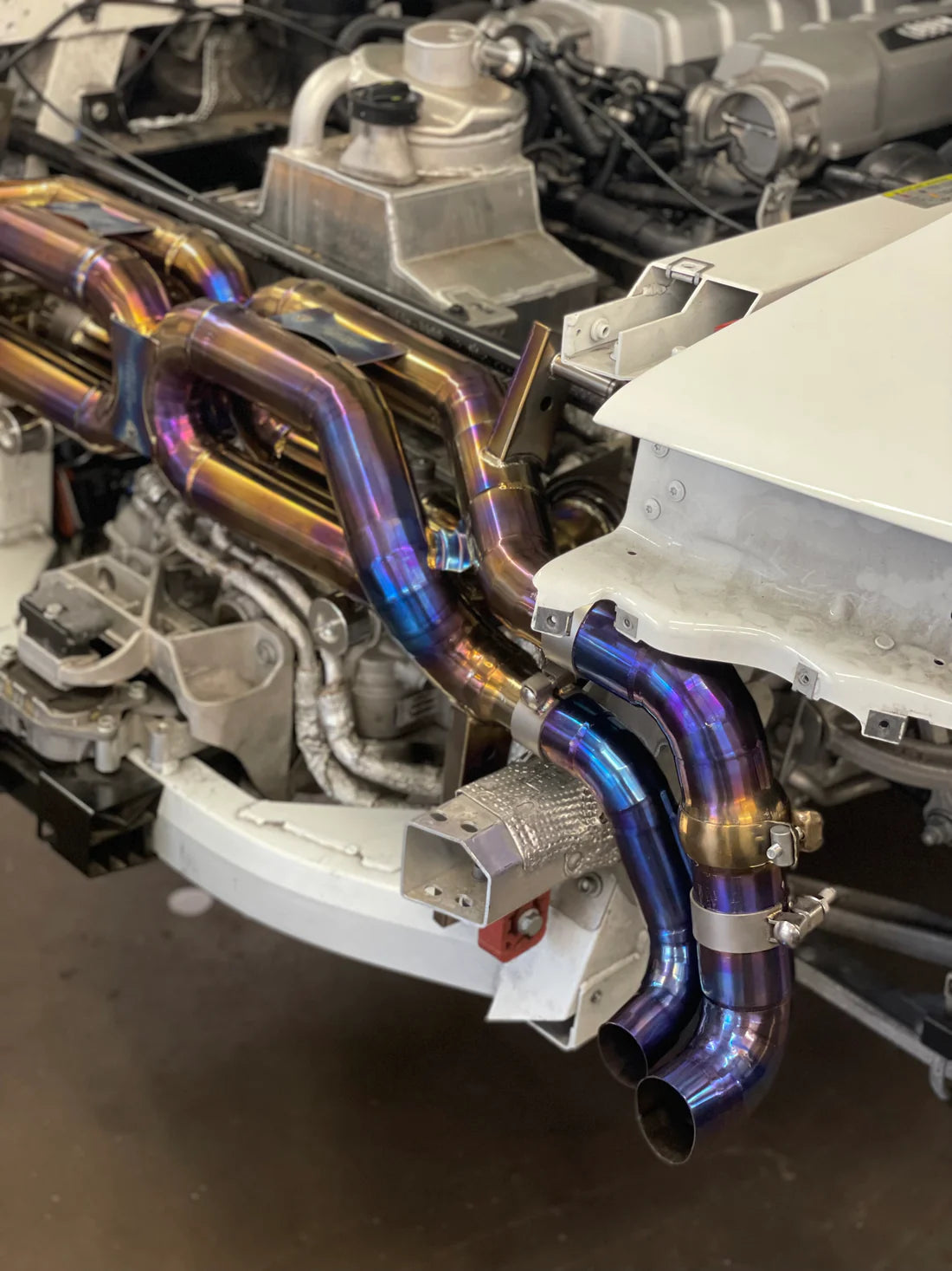 A side view of Valvetronic Designs Valved Sport Exhaust System (for Audi R8 V10 / Lamborghini HuracanF1) fixed on a car.