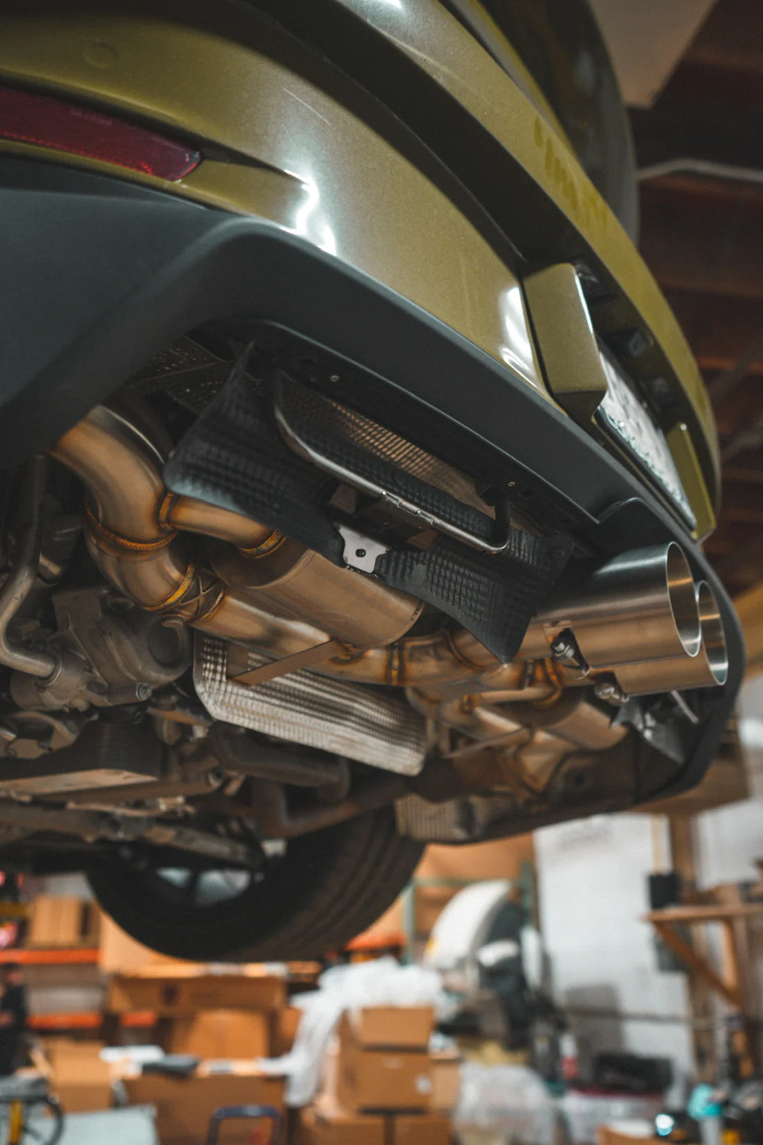 A close overview of Valvetronic Designs Valved Sport Exhaust System fitted on a lifted car (for Porsche 992 GT3/ RS).