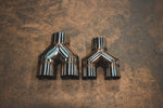 A top-down view of two stainless steel Y-pipe adapters of different sizes, showcasing the symmetrical Y-shape design and interior pipe openings.