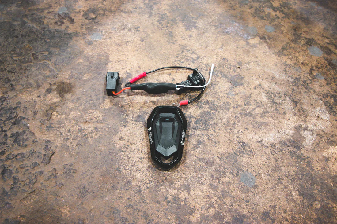 A close overview of Valvetronic Designs Valved Sport Exhaust System's valve controller on the ground (for BMW F10 M5 / F12 M6 / F06 M6).