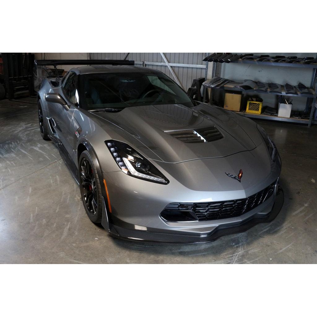 Black carbon fiber front airdam splitter installed on silver Corvette in garage setting - APR Performance front airdam for Chevrolet C7 Corvette Corvette Z06