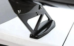 A close up view of APR Performance GTC-300 Adjustable Wing for Dodge Charger 2006-2010 on a white car