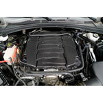 Carbon fiber engine cover installed in Camaro engine bay with twill weave pattern and raised design elements - APR Performance engine cover for Chevrolet Camaro SS LT1