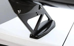 A close up view of APR Performance GTC-300 67" Adjustable Wing for Chevrolet Camaro 2016-2023 fitted on a white car