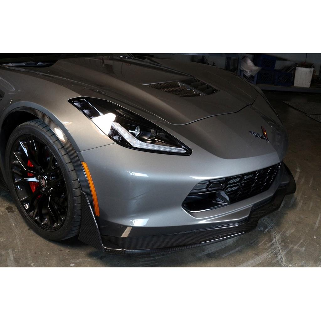 Black carbon fiber front airdam installed on silver Corvette Z06 positioned in garage setting - APR Performance front airdam for Chevrolet C7 Corvette Corvette Z06