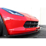 Black carbon fiber front canards mounted on lower corners of red Corvette front bumper beside air intakes - APR Performance front canards for Chevrolet C7 Corvette Z06