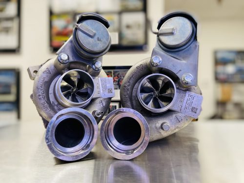A front wide view of Pure Turbos Turbo Upgrade Pure850 for Porsche Panamera (4.8L V8) 2010-2016 sitting on a metal shelf