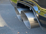 A side close up view of Shark Werks Track Exhaust for Porsche 991 / 991.2 GT3 / RS exhaust tips fitted on a car outside