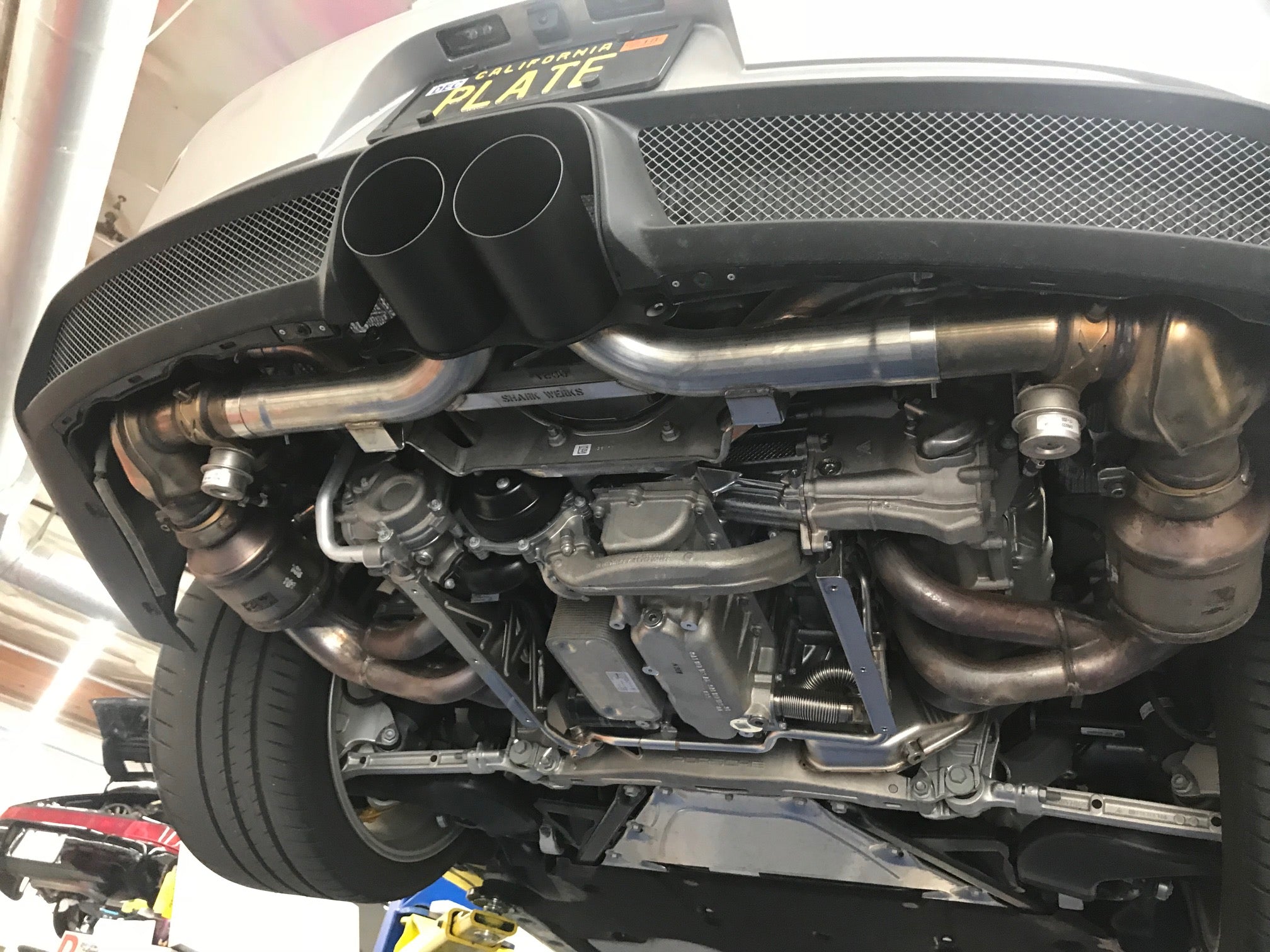 A wide view of Shark Werks Sport Exhaust for Porsche 991 GT3 / RS and 991.2 GT3 / R fitted on a car from behind