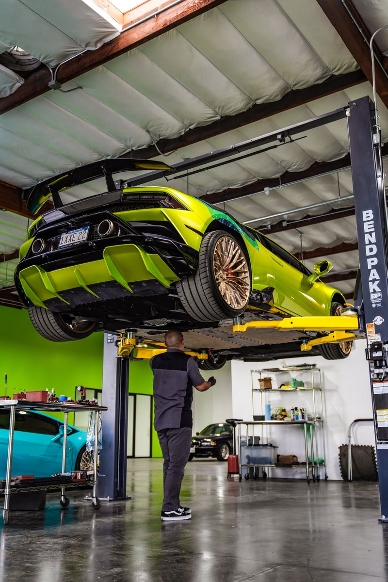 Lime green Lamborghini Huracan Evo on a lift showing the carbon rear diffuser