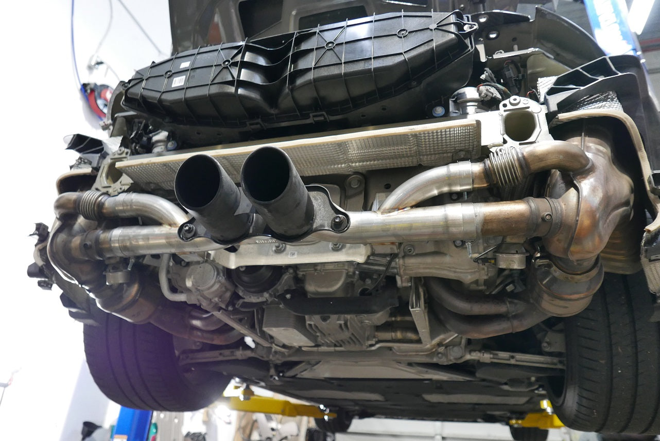 A wide view of Shark Werks Sport Exhaust for Porsche 991 GT3 / RS and 991.2 GT3 / R fitted on a car from behind