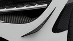 Carbon canards on the front bumper of a white McLaren 750S