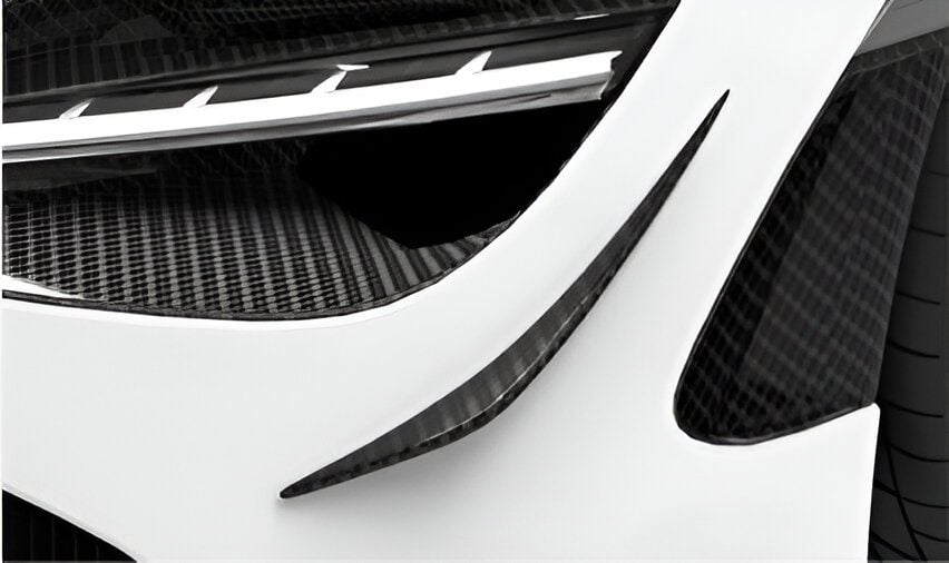 Carbon dive canards on the front bumper of a white McLaren 720S