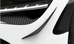 Carbon dive canards on the front bumper of a white McLaren 720S