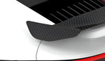 Carbon wing tip on a white Porsche 911 Turbo S (992) rear wing, close-up render