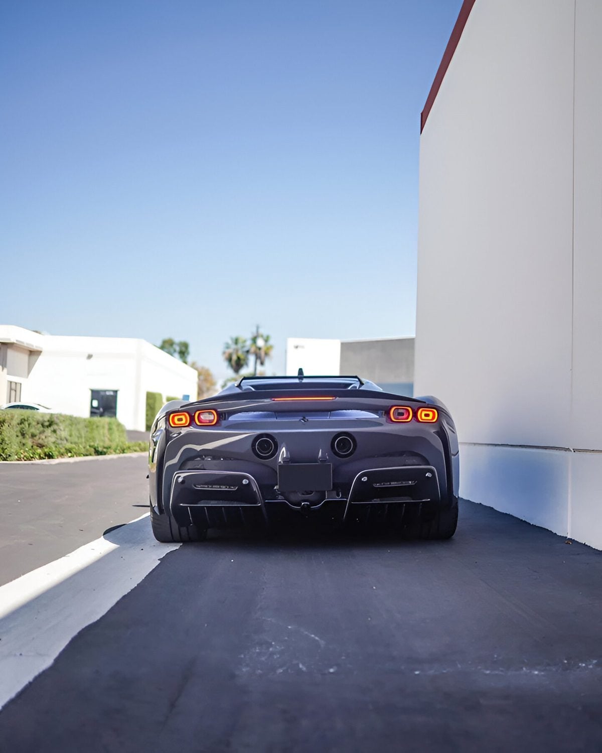 Grey Ferrari SF90 straight rear view showing the rear diffuser
