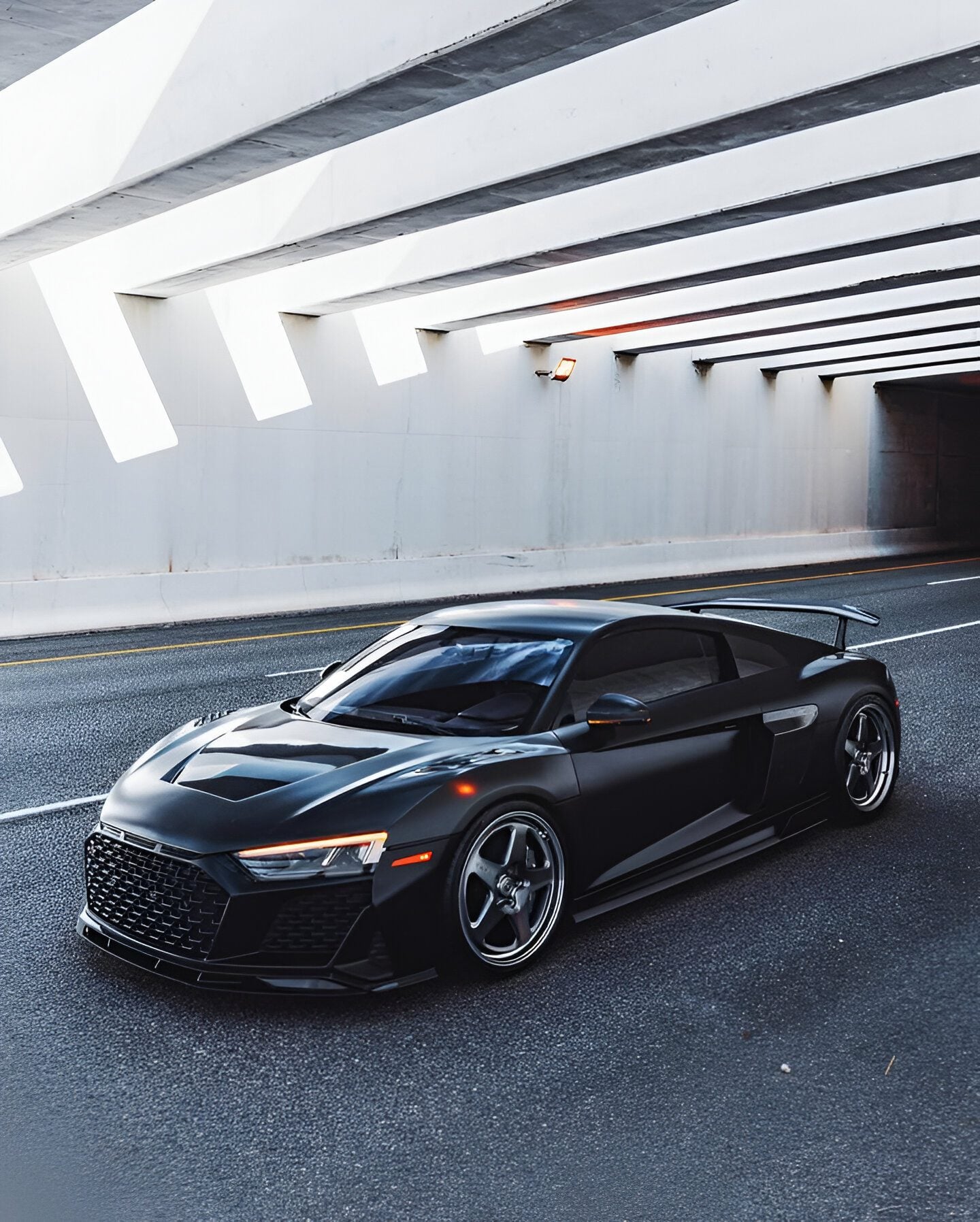 Black Audi R8 2020+ front three-quarter with the complete aero kit, tunnel exit