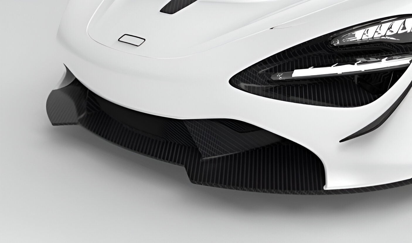720S front bumper with carbon splitter fitted on a white car, close-up