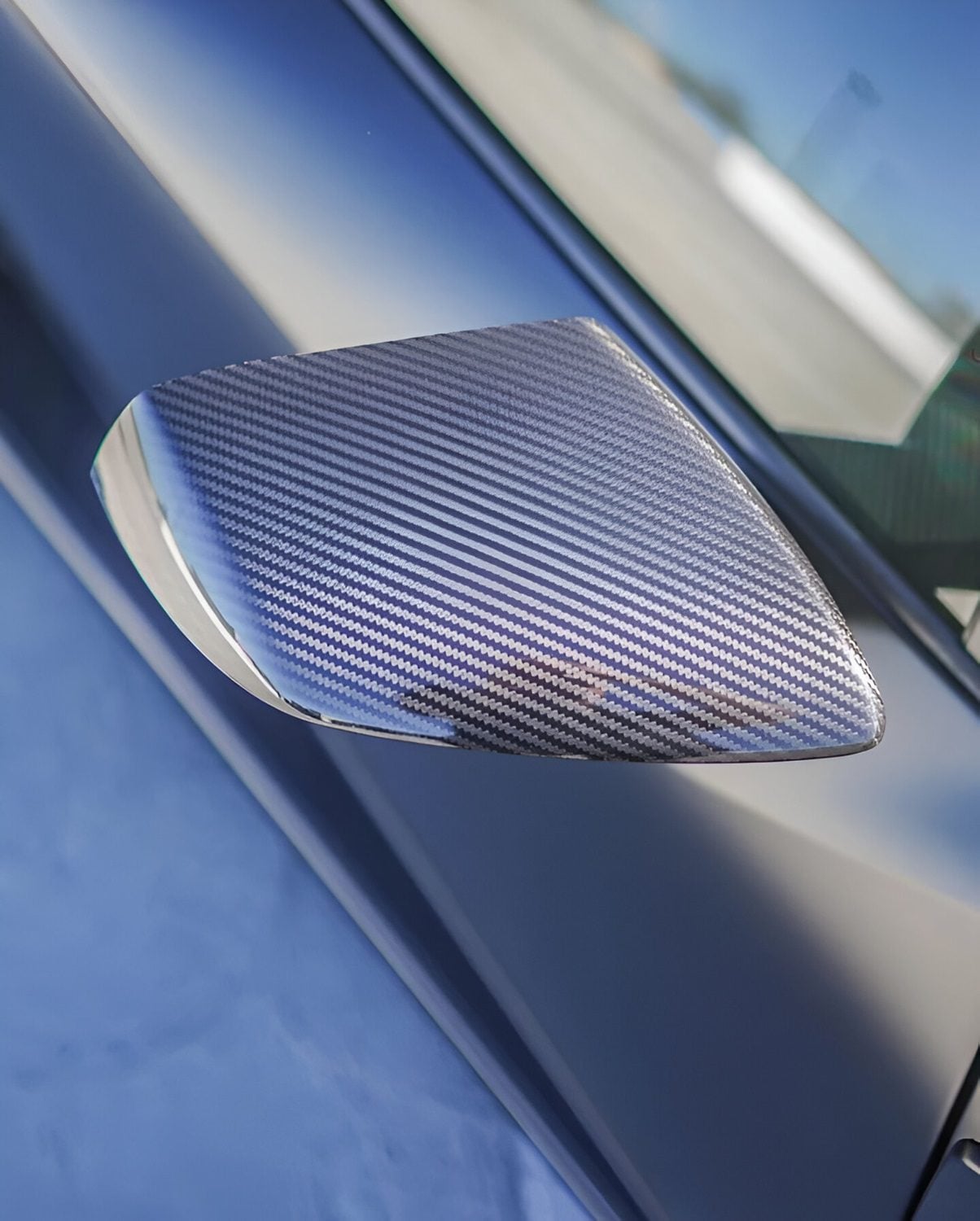 Carbon mirror cap on a matte black Lamborghini Huracan STO, close-up