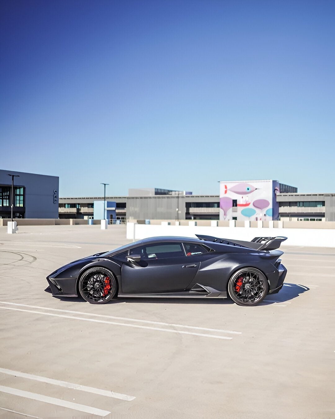 Grey Huracan STO side profile on a rooftop showing side skirts