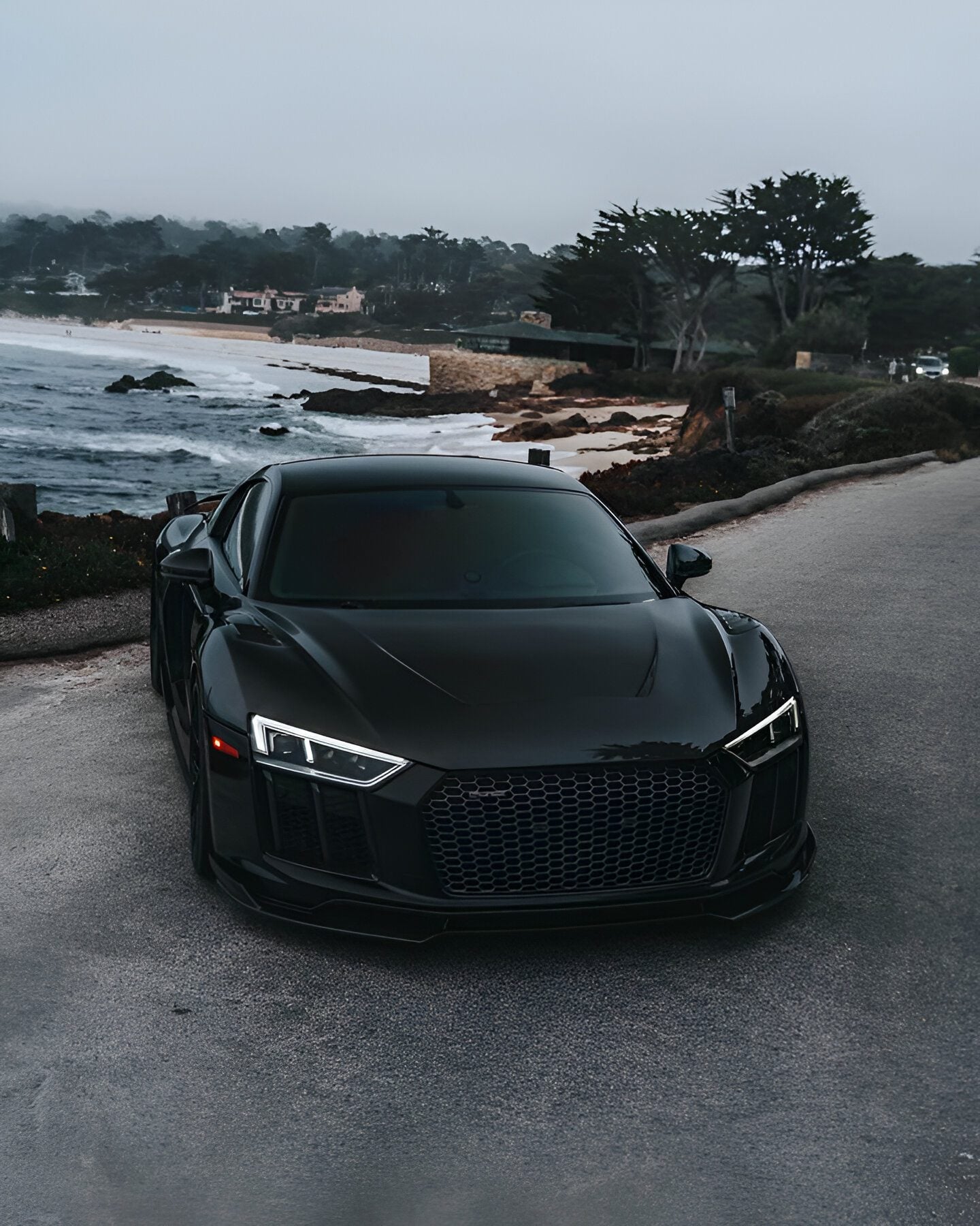Black Audi R8 (4S) front view with the complete aero kit by the coast