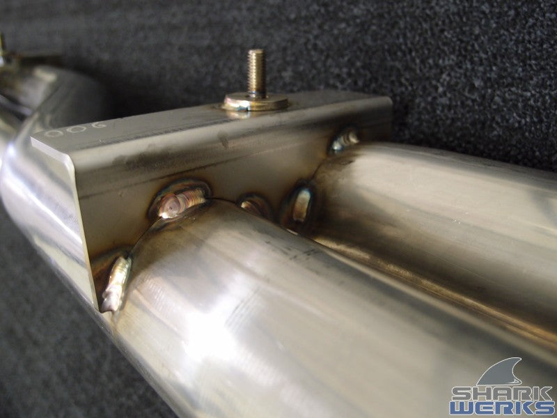 A close up view of Shark Werks Exhaust for Porsche 997 GT2 and GT2RS pipe with a black background