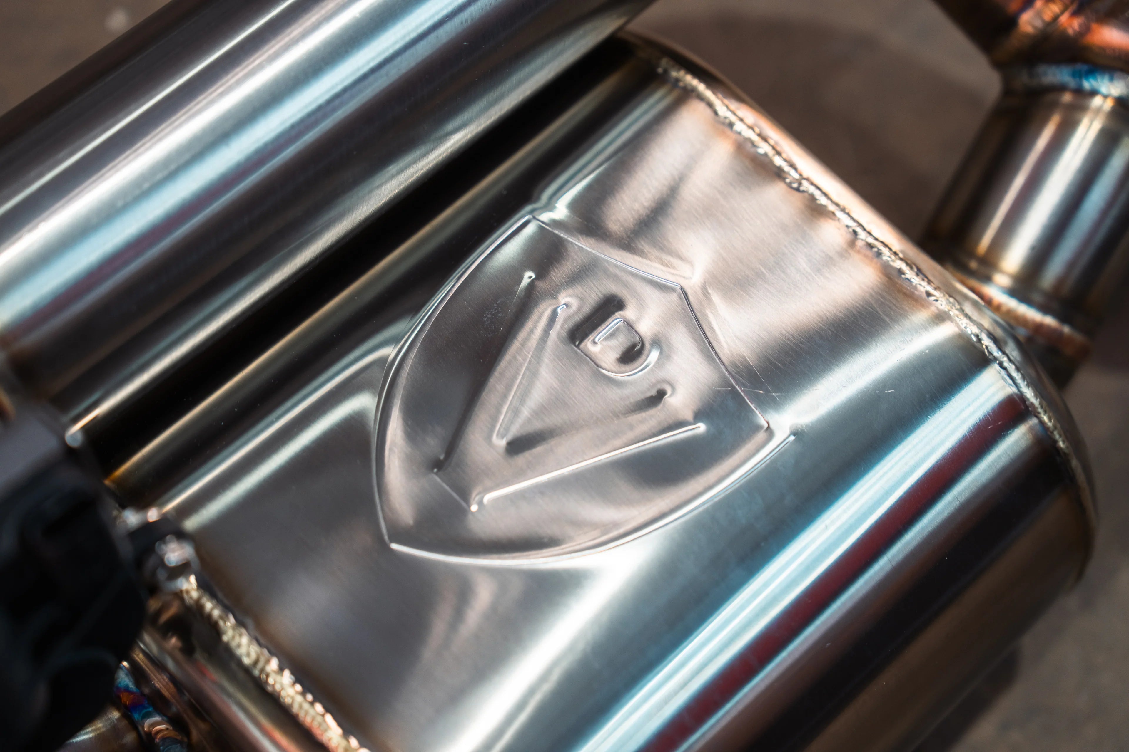 Valvetronic Designs shield logo embossed on T304 stainless muffler body of Blackbear Ram 1500 valved exhaust - AutoTalent