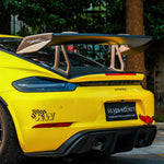 Rear view of a yellow GT4rs with silver rocket carbon wing