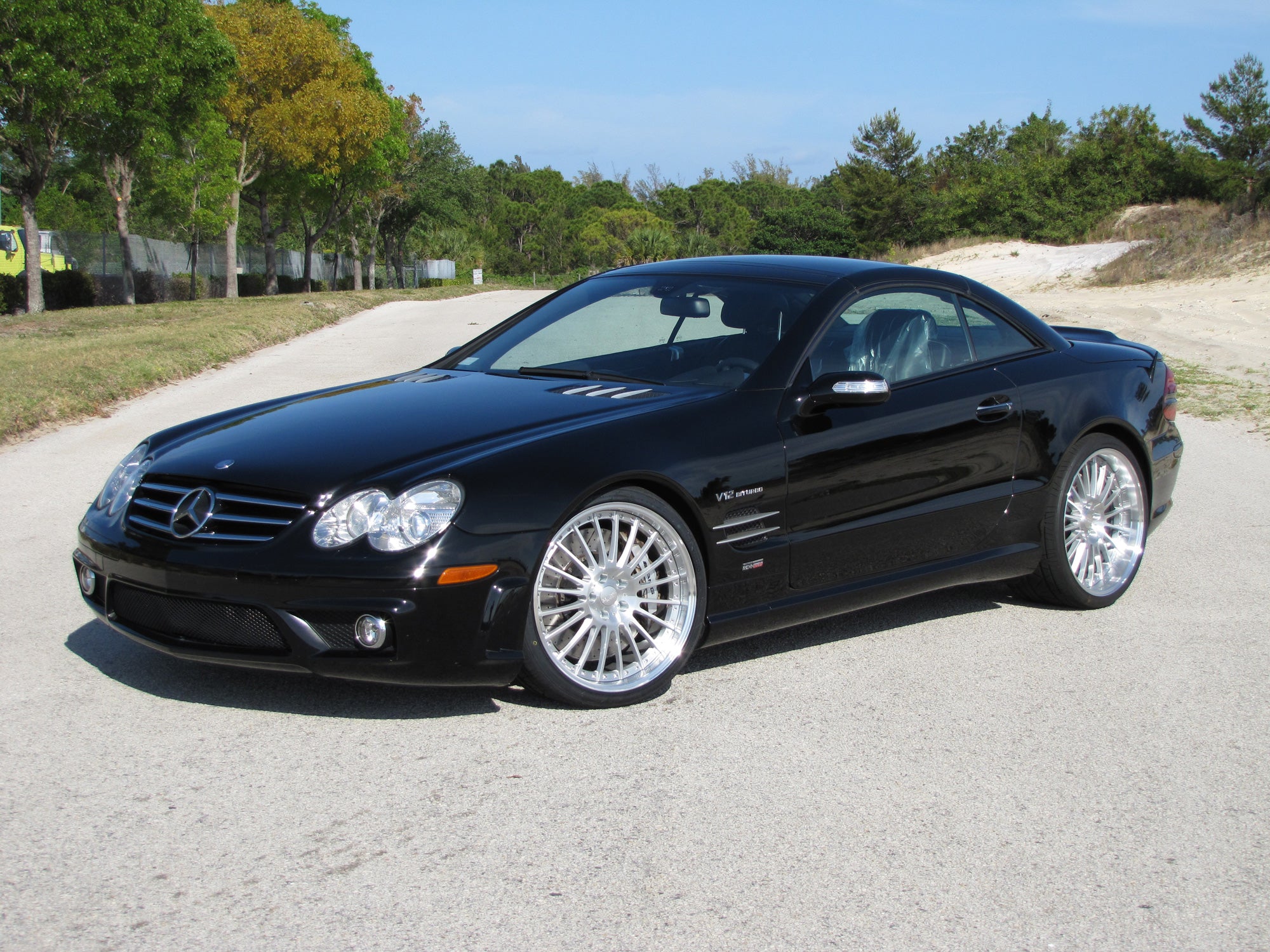 Black SL car front three-quarter on the RennTech wheels - Multi-Spoke 20/21-inch Wheels for the 2003-2020 SL-Class