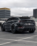 Black Lamborghini Urus rear three-quarter in a parking structure