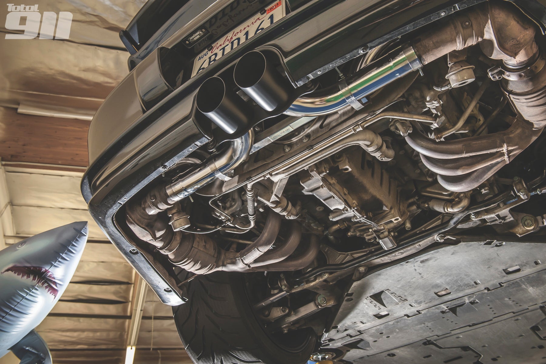 A wide view of Shark Werks Light Weight Exhaust Tips for Porsche 997 / 997.2 GT3 / RS fitted on a car from underneath