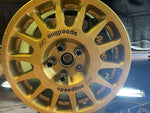 A view of AP Racing by Essex Rally Competition Brake Kit (Front CP8350/299mm)- Subaru 2.5RS, WRX, STI fitted on a gold wheel