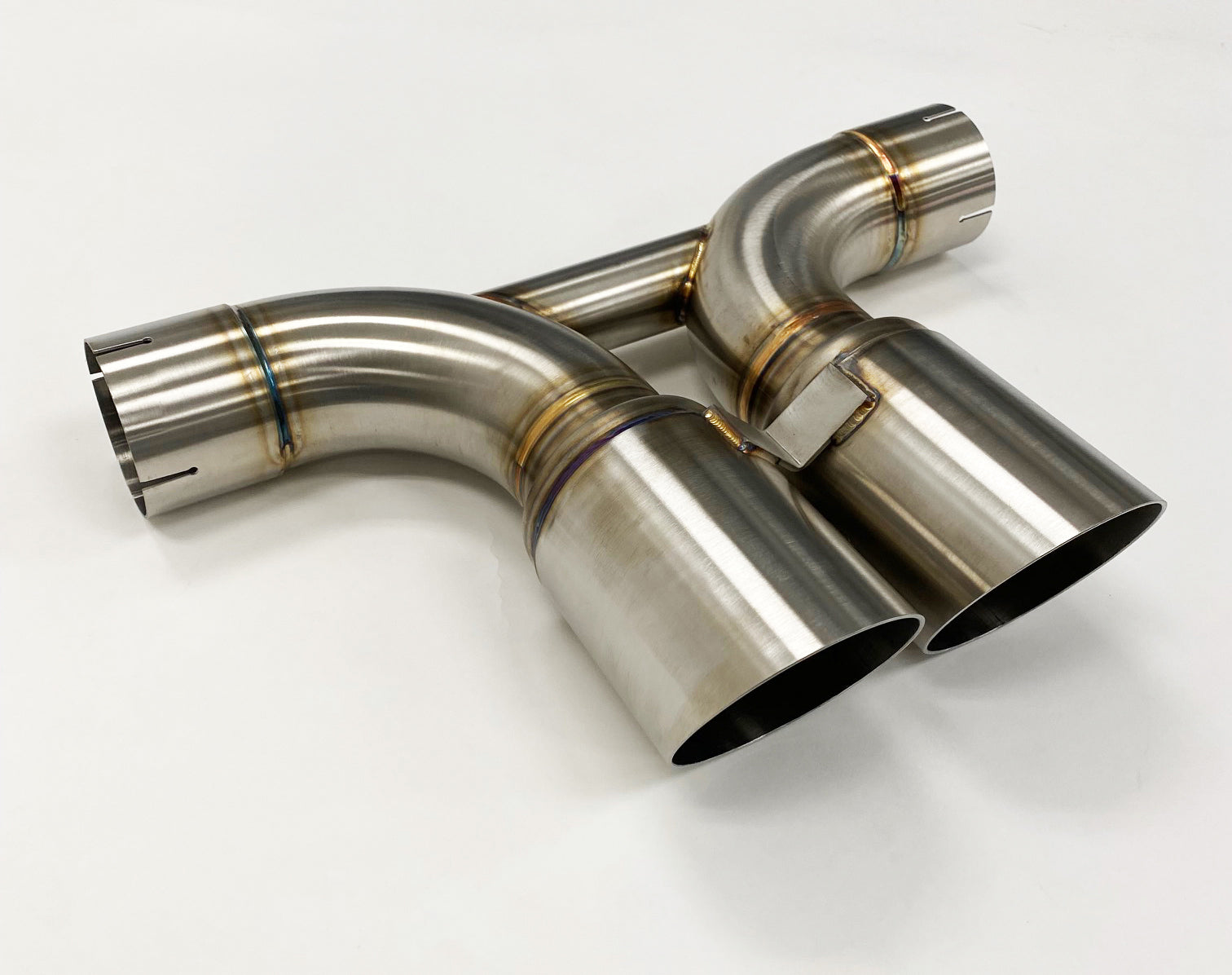 A side wide view of Shark Werks Exhaust System for Porsche 992 GT3 / GT3RS exhaust tips with a white background