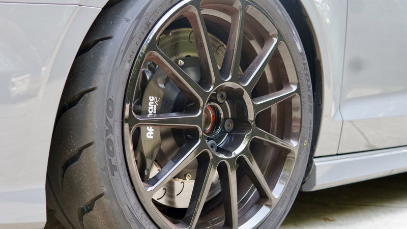 A close up view of a wheel fitted with AP Racing by Essex Radi-CAL ENP Competition Brake Kit (Front CP9660/372mm)- Audi RS 3 (8V)