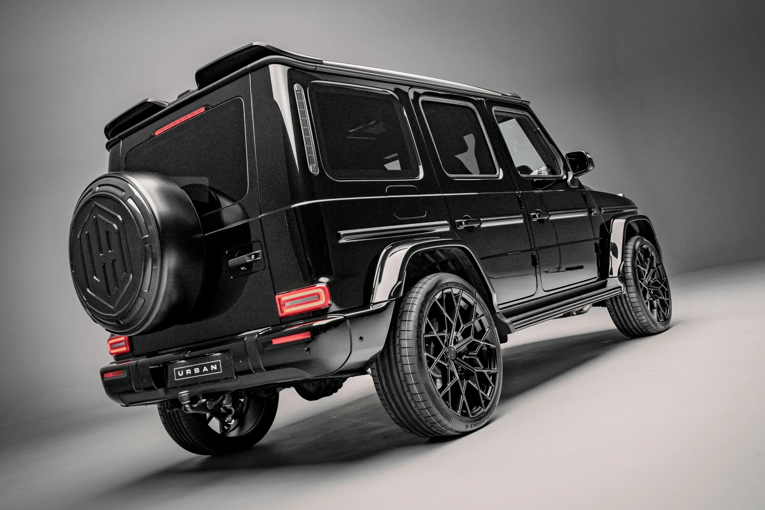 Urban carbon upper rear spoiler and UA Icon spare wheel cover on a G63 W465