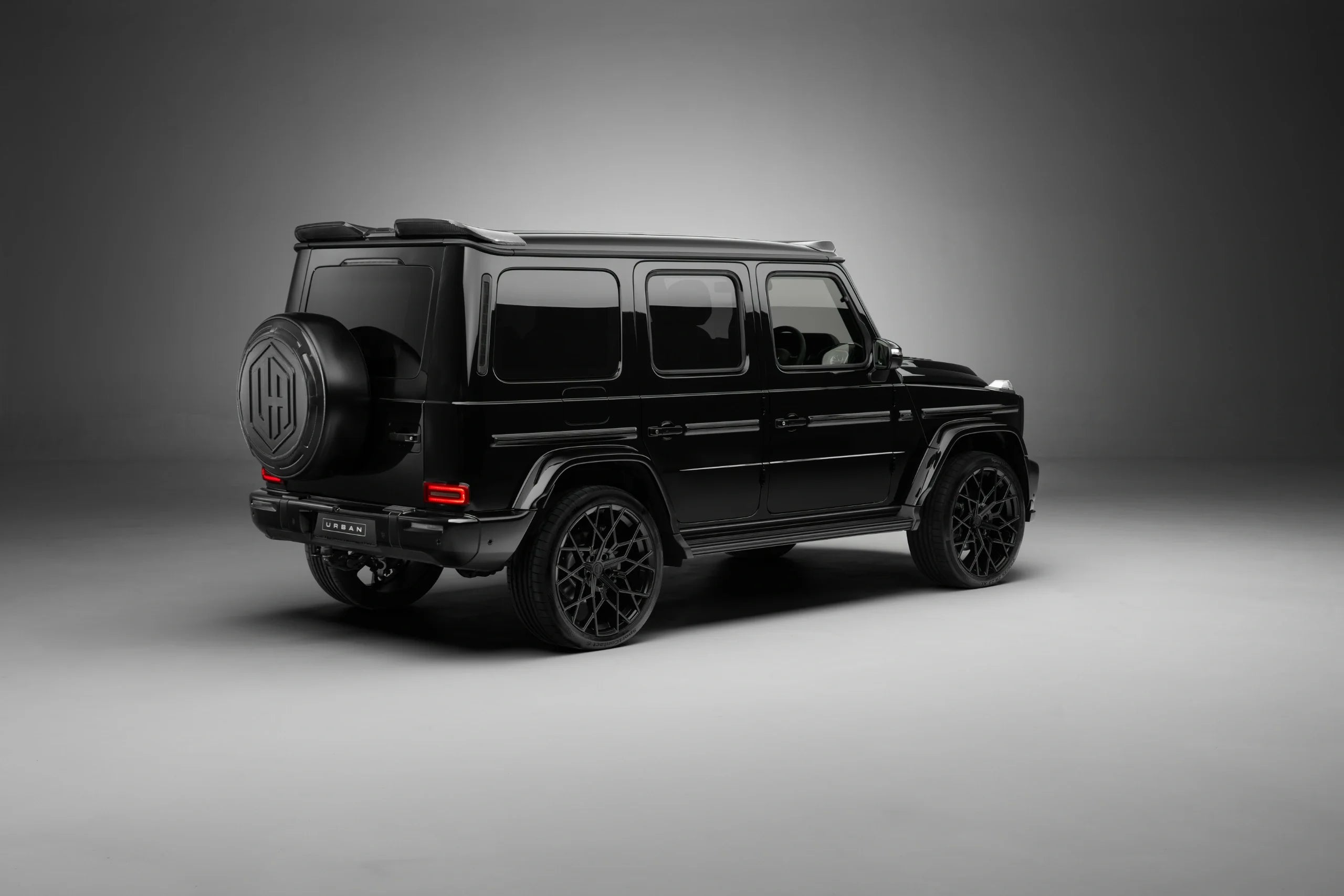 Rear three-quarter view of the Urban Aero Kit on a black Mercedes-AMG G63 W465