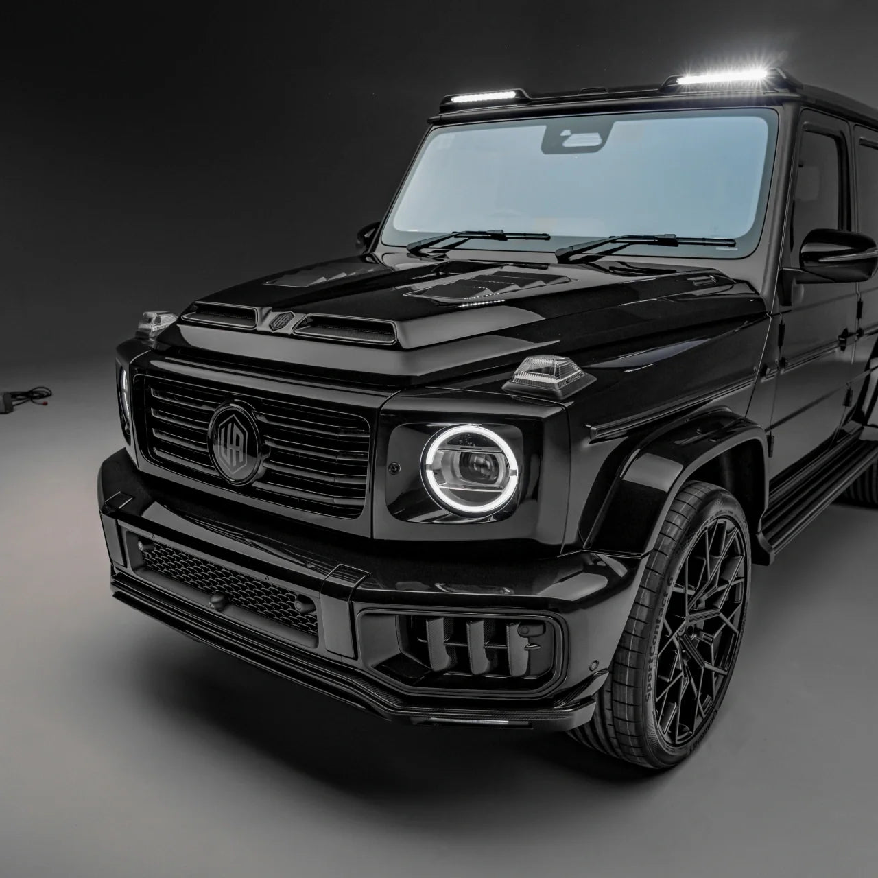 Urban G63 W465 Aero Kit front splitter and grille center icon, lit roof light bar