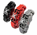 A side view of red, black and silver calipers of the AP Racing by Essex Road Brake Kit (Front 9562/380mm)- F87 BMW M2 & M2 Competition, F80 M3, F82 M4 with a white background