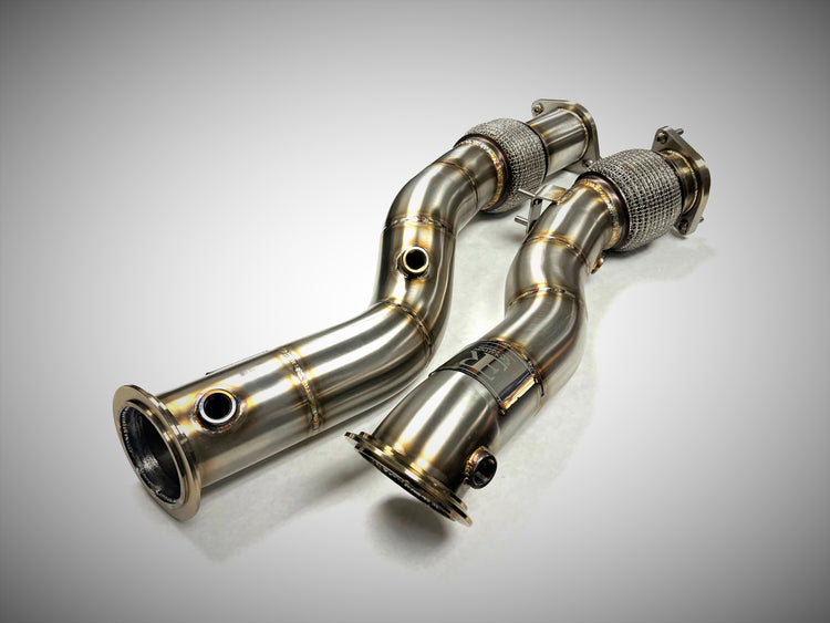 A top view of Evolution Racewerks Competition Series Catless Downpipes BMW X3M/X4M S58 Engine in Brushed Finish